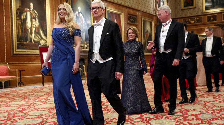 Tiffany Trump smiles as she walks alongside Apple CEO, Tim Cook, at Windsor Castle