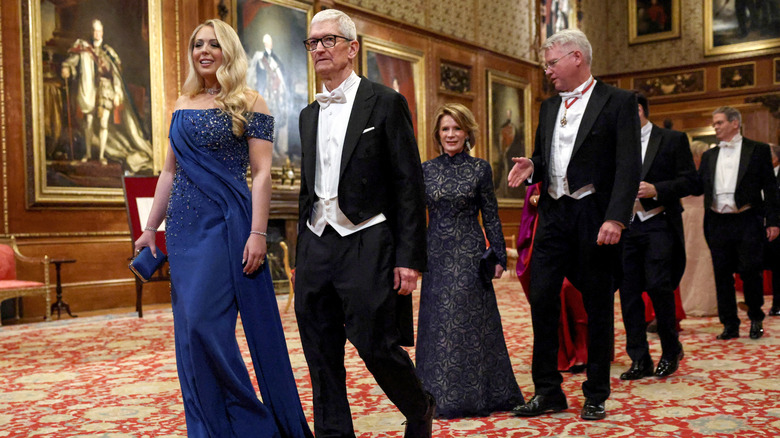 Tiffany Trump smiles as she walks alongside Apple CEO, Tim Cook, at Windsor Castle