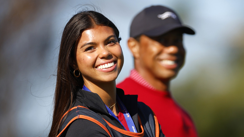 Sam Woods smiling alongside Tiger Woods