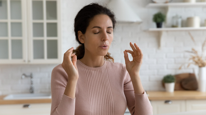 Woman deeply breathing in a stressful moment