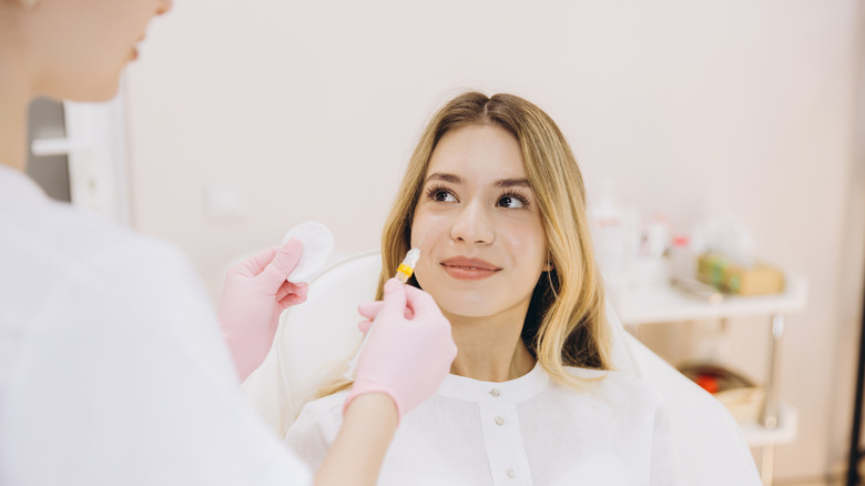 A woman preparing for facial surgery