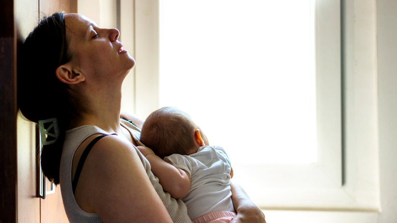 Tired mom holding a baby 