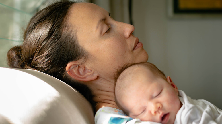 Tired mom holding a baby 