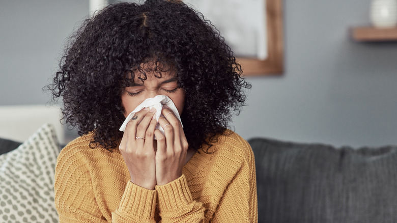 Woman sneezing