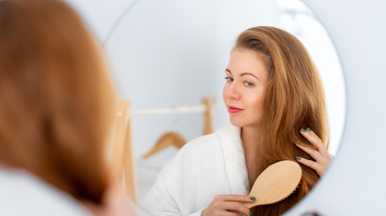 redhead brushes hair