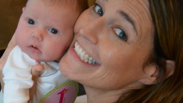 Savannah Guthrie posing with her baby daughter