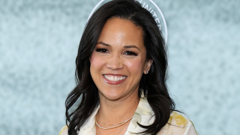 Laura Jarrett smiling in front of a light blue background