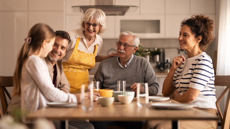 A multi-generational family gathered around a table