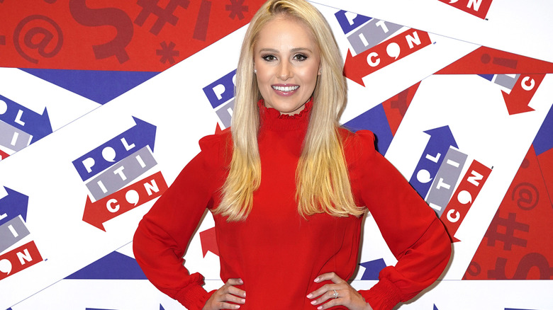Tomi Lahren smiles on the red carpet in 2019