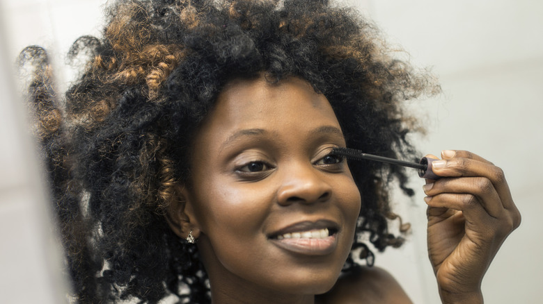 Woman applying mascara