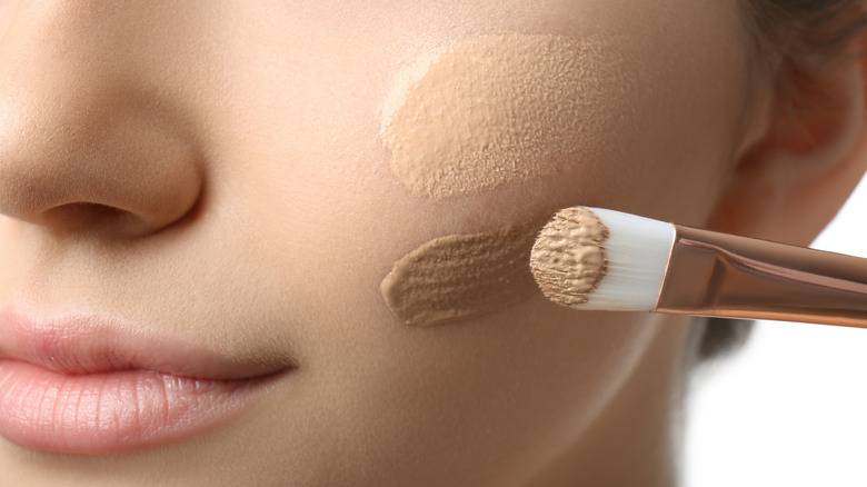 Girl applying foundation