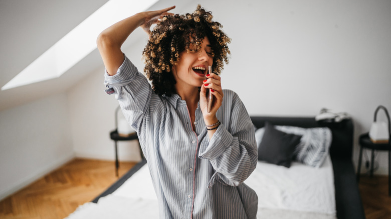 woman singing in bedroom