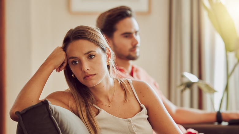 An unhappy couple on the couch 