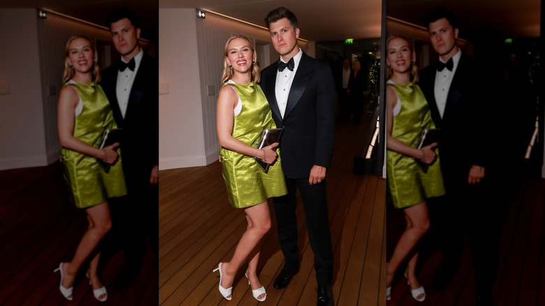 Scarlett Johansson and Colin Jost posing for photographs at a party