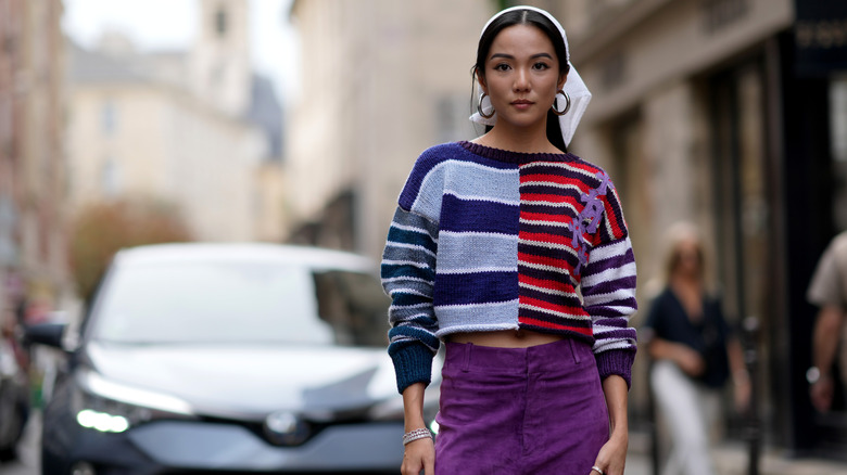 Woman wearing a knit sweater with suede pants