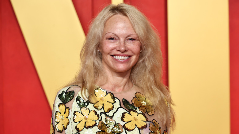 Pamela Anderson smiles on the red carpet in 2025
