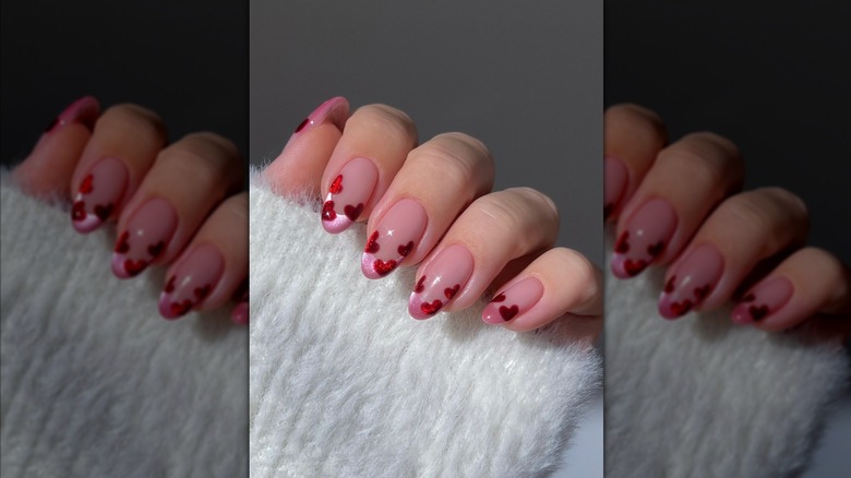 Pink Valentine's manicure with red hearts