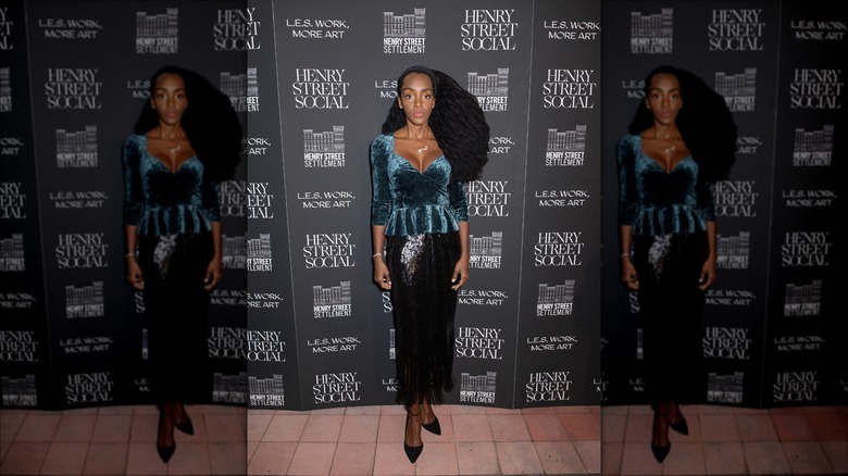 Woman wearing velvet peplum top and skirt