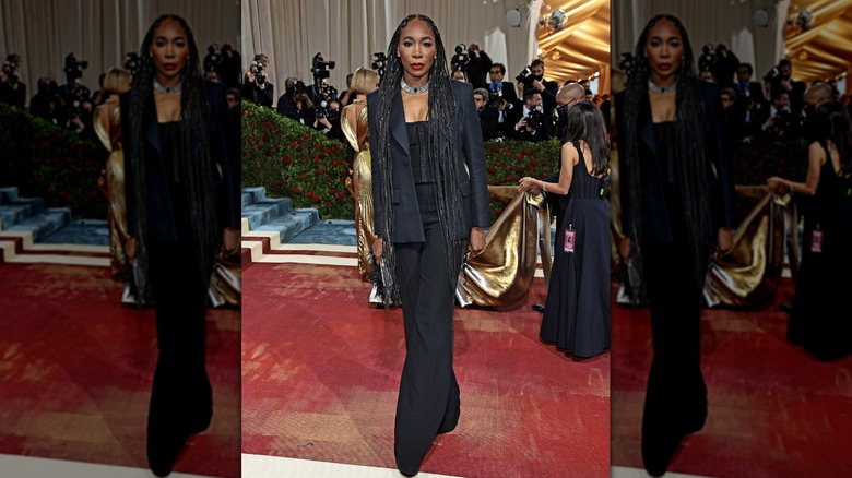 Venus Williams poses wearing a black three-piece suit