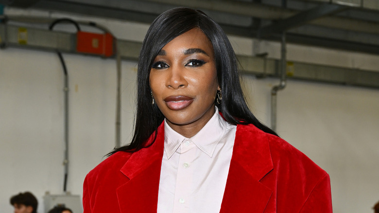 Venus Williams smiles in a red blazer and shirt
