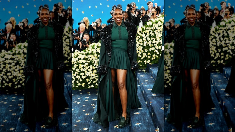 Venus Williams poses wearing a green dress and cape