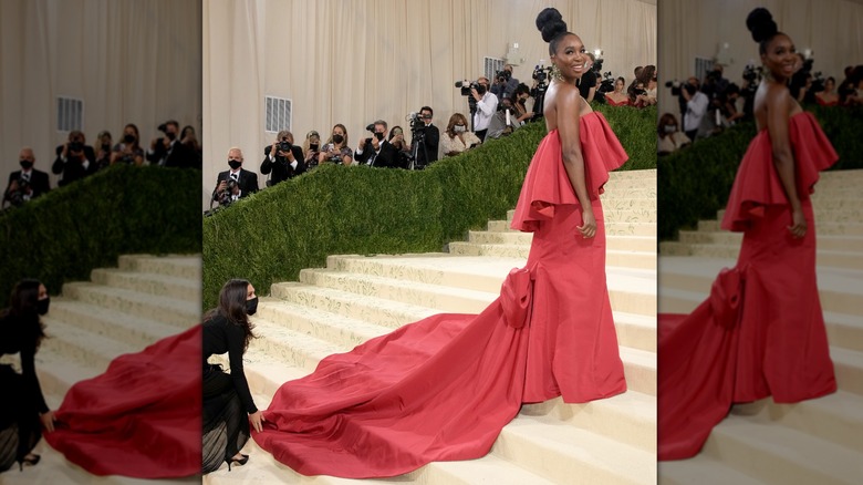 Venus Williams smiles wearing a red gown