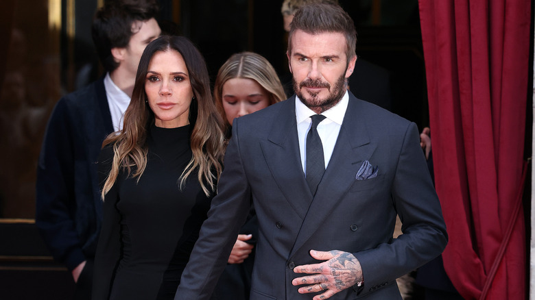 David Beckham and Victoria Beckham posing together on a red carpet
