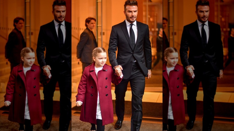 Harper and David Beckham holding hands