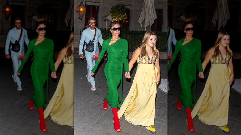 Harper Beckham and Victoria Beckham holding hands