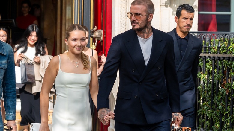 Harper and David Beckham holding hands