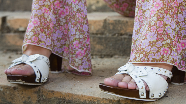 Woman's legs with flora pants and clog sandals