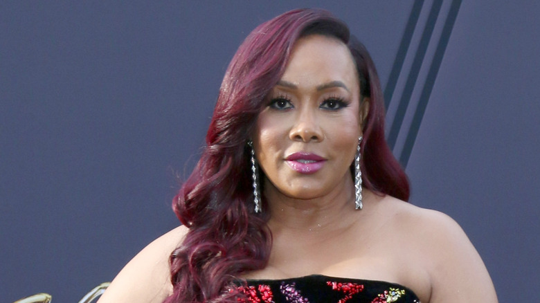 Vivica A. Fox with red hair on a red carpet