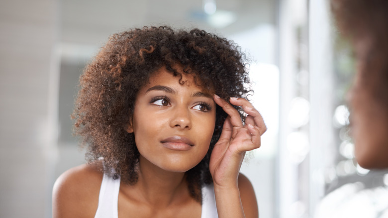 Woman touching her eyebrows