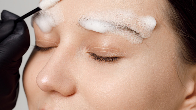 Soap on woman's eyebrows