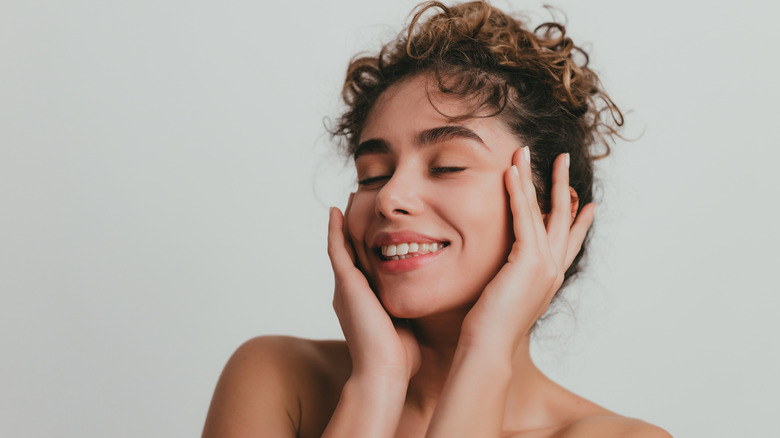 Woman applying skincare