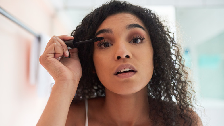 Woman applying mascara