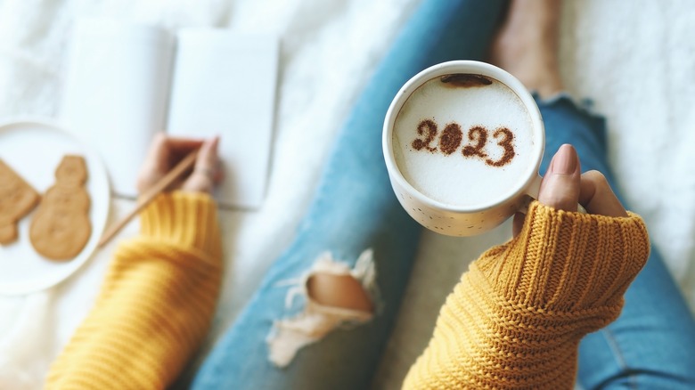 Woman setting goals and drinking coffee
