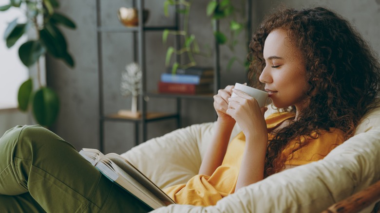 Woman drinking tea and reading