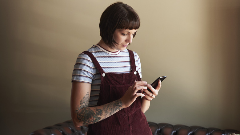 Woman wearing burgundy overalls