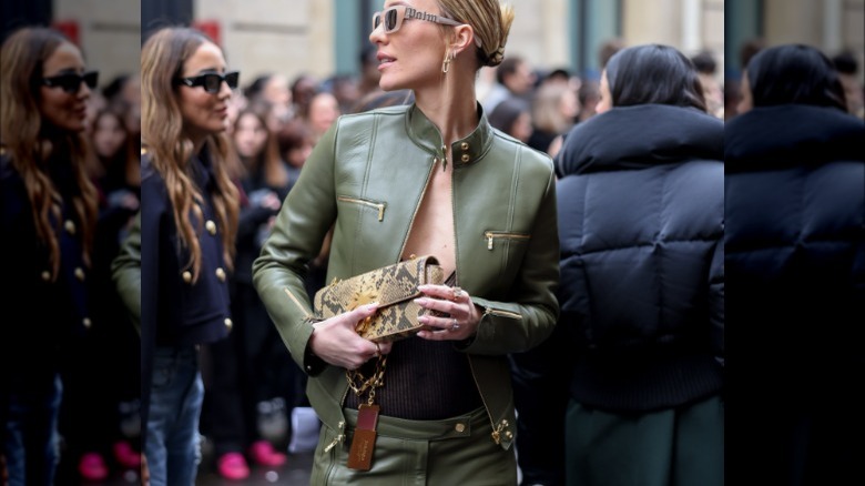 Woman holding a snakeskin clutch bag