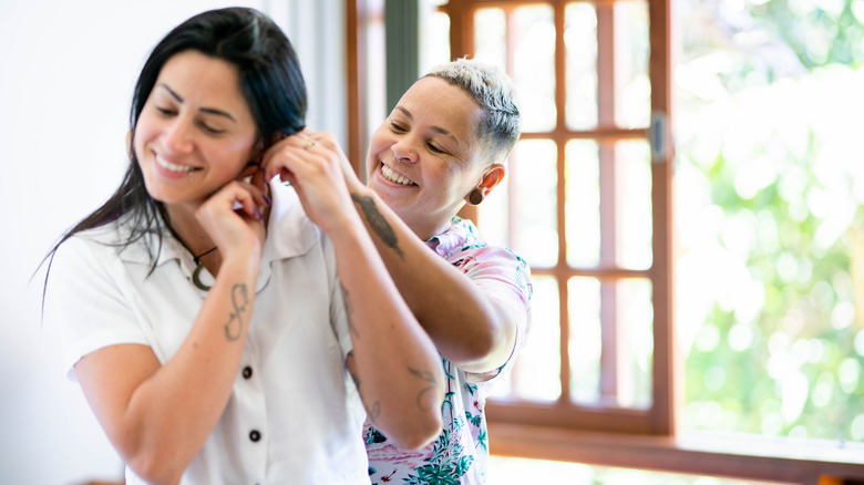 Person helping someone with earring