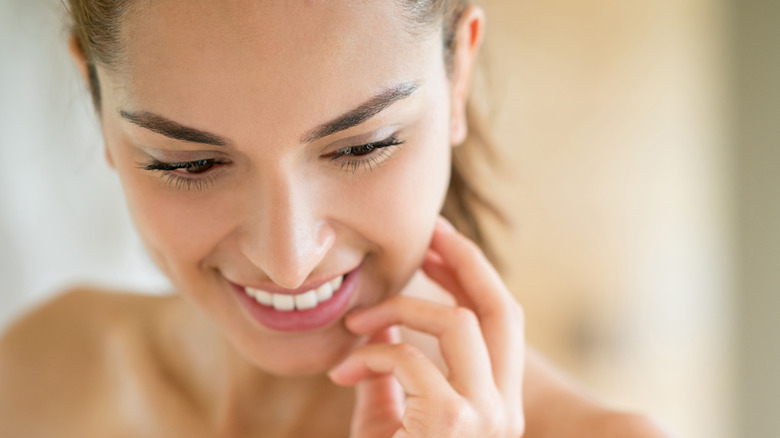 Woman touching face
