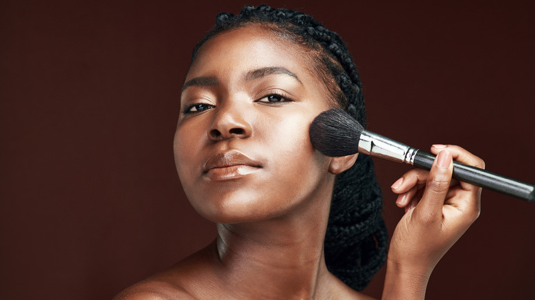 Woman using makeup brush