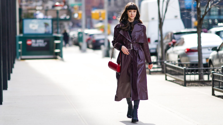 A woman in a purple leather trench coat 