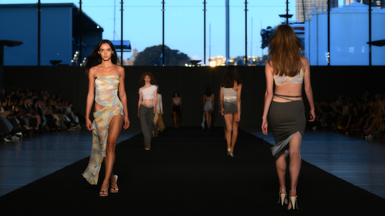 Models walk the runway at a cruise fashion show