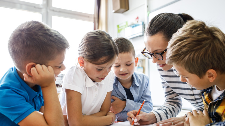 A teacher surrounded by students