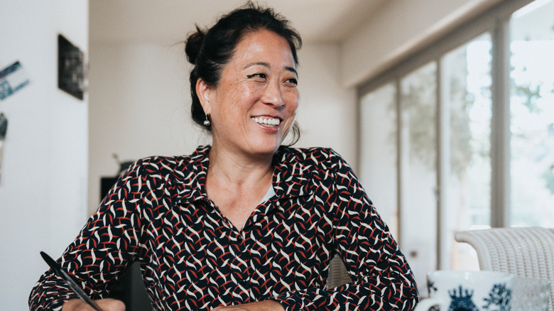 A smiling woman with a pen