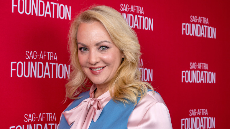 Wendi McLendon-Covey in a pink blouse and a blue vest