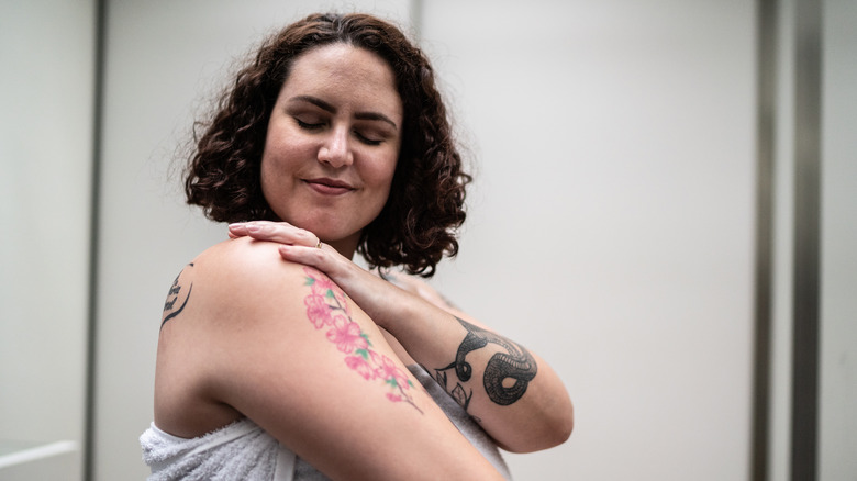 Woman with tattoos smiling