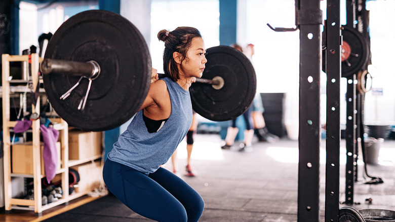 woman lifting heavy weight